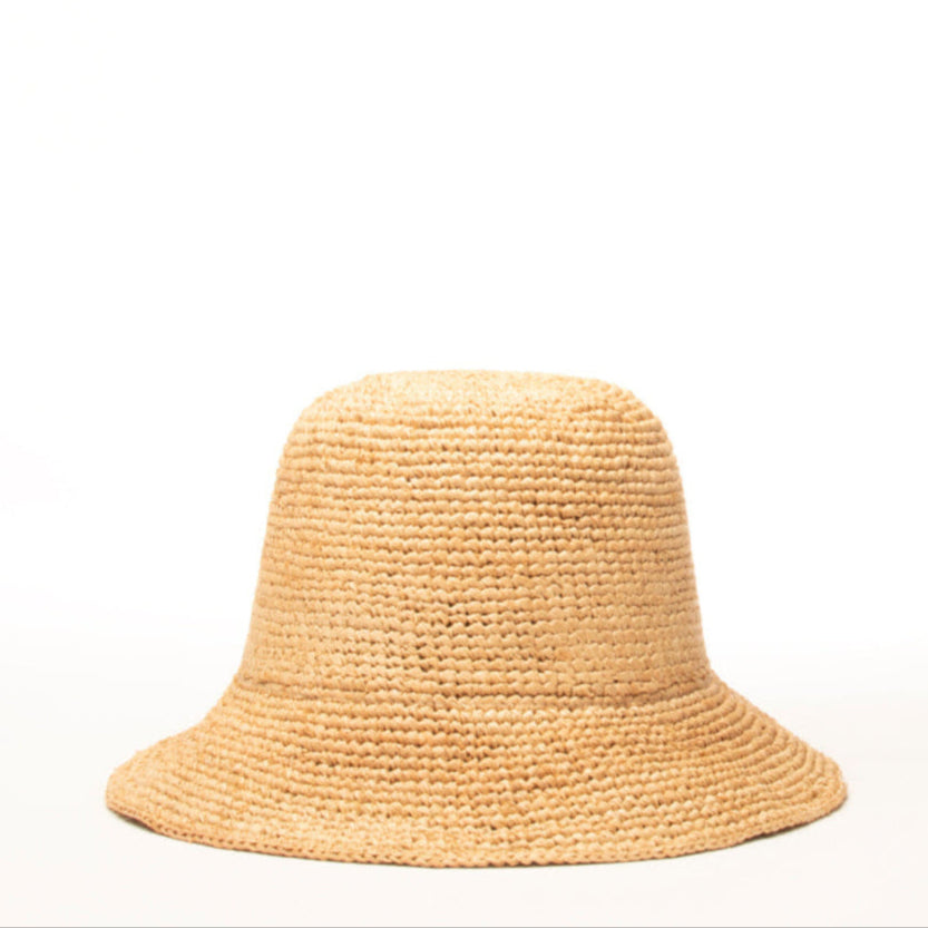 The Belmar hat, a natural grass woven bucket with a protective brim by Per Lei New York.
