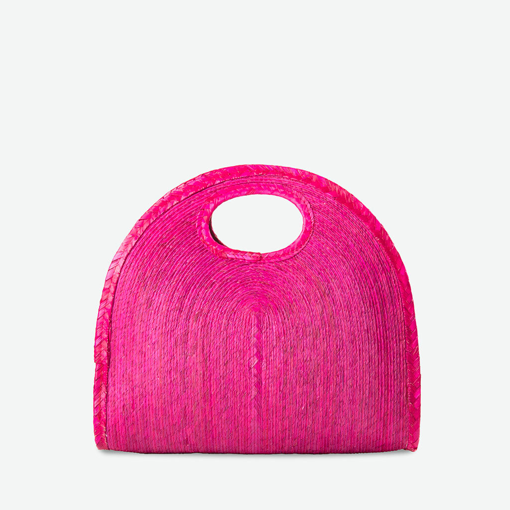 Pink woven handbag on a white background