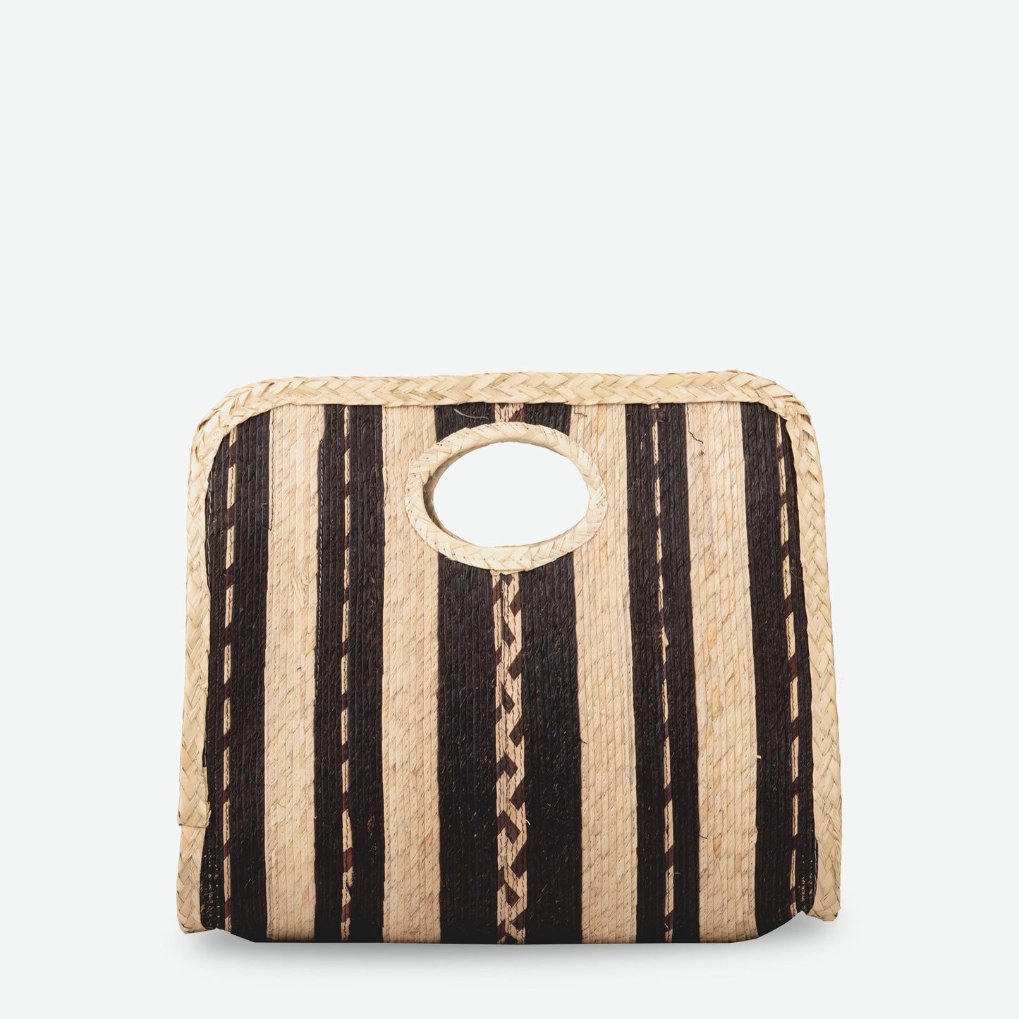 A square straw tote bag with black and natural color stripes, featuring a top handle.