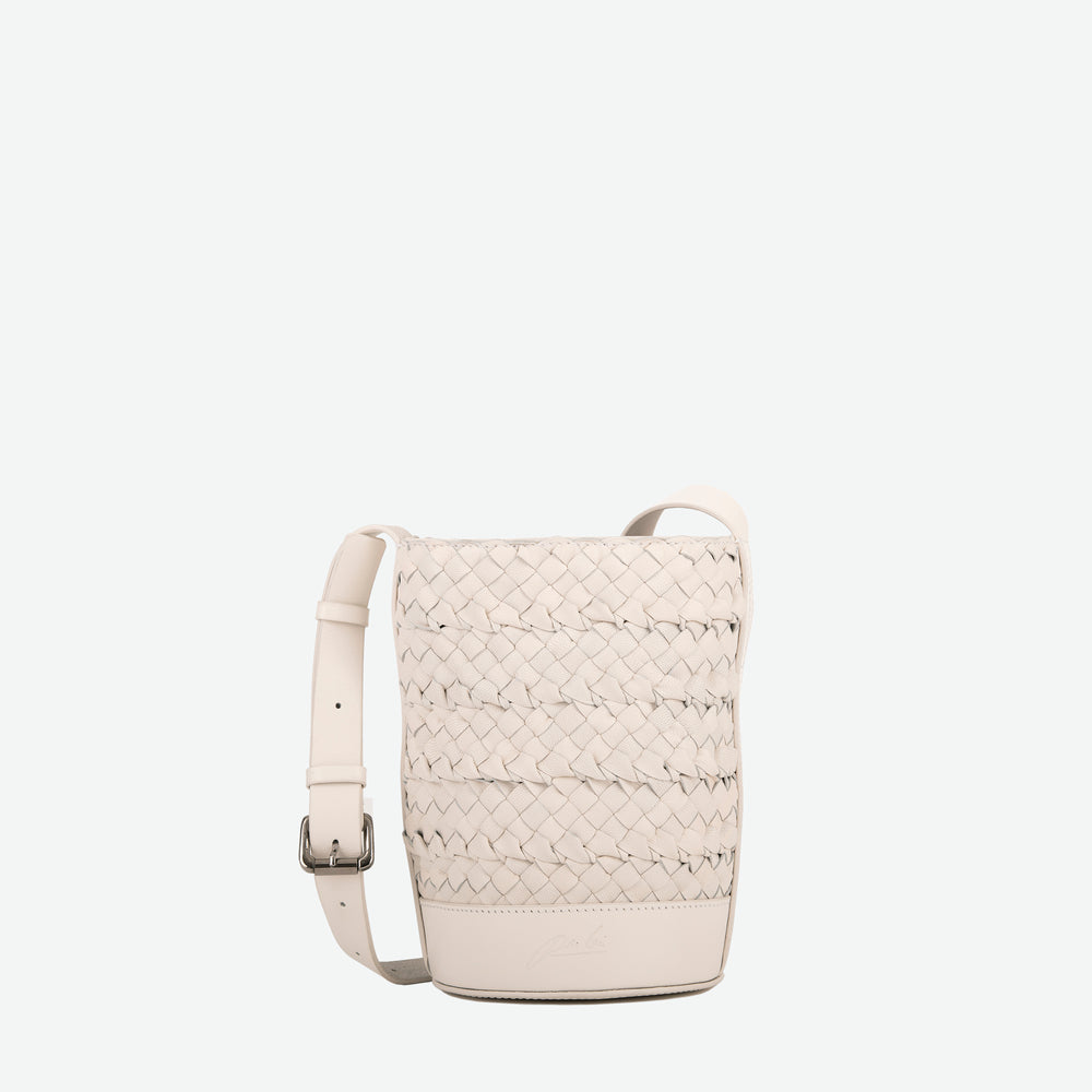 
                  
                    A mini small stone white woven leather bucket bag  with an adjustable crossbody strap - image 1
                  
                