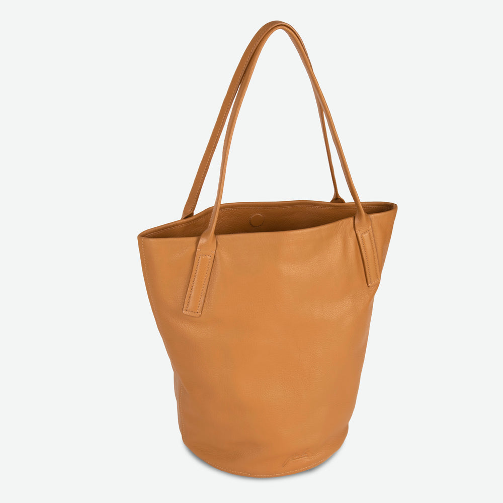 
                  
                    Caramel smooth leather bucket tote with rounded base, dual shoulder straps, and open-top design
                  
                
